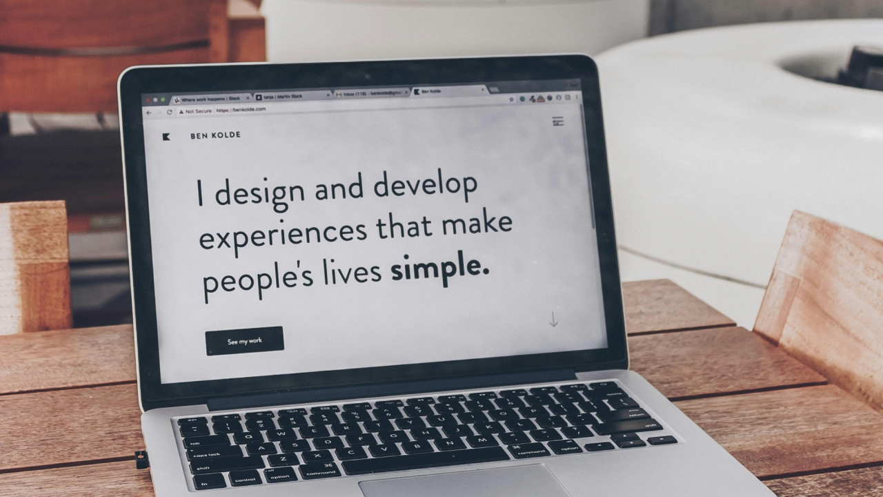 Laptop displaying UX Design portfolio website with text "I design and develop experiences that make people's lives simple."